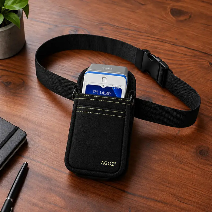 Agoz black waist belt holster holding a myPOS handheld payment terminal on a wooden desk, with adjustable strap and buckle.