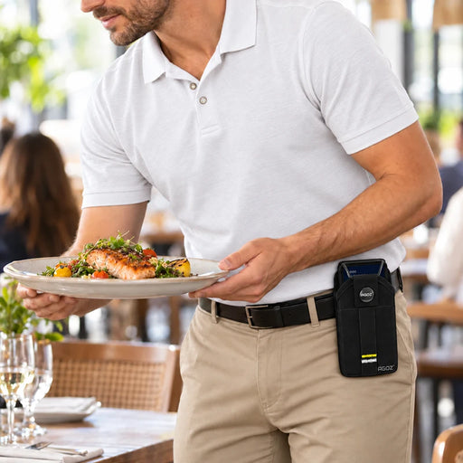 Restaurant server carrying a plated meal with an Adyen AMS1 POS terminal secured in an Agoz black holster attached to his waist belt.