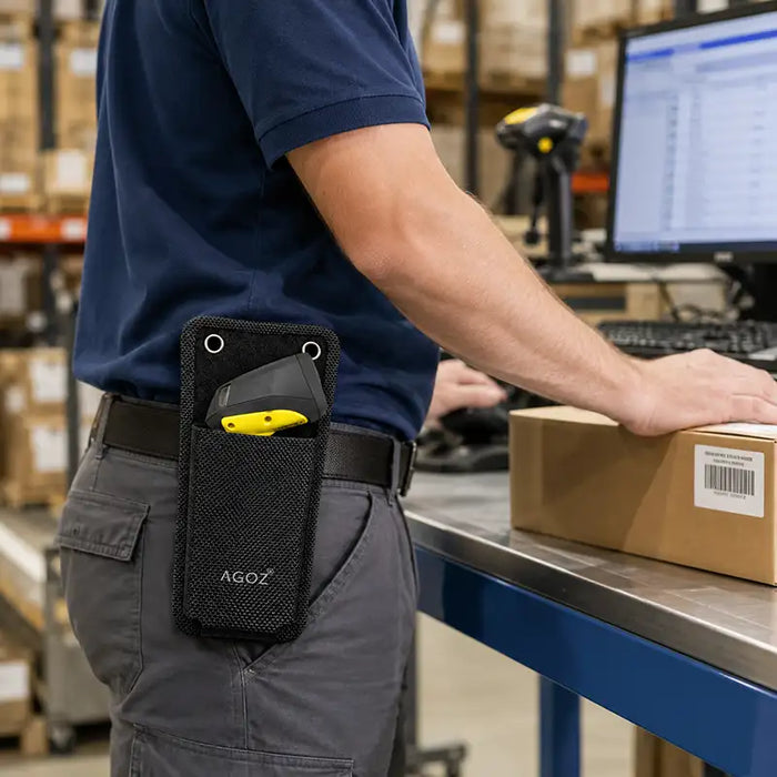 Worker wearing an Agoz wireless scanner mountable case with a WASP scanner while handling a package at a warehouse packing workstation.