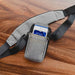 Gray myPOS Mobile Terminal Holster with shoulder strap on wood tabletop