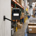 Citizen mobile printer swing arm mount installed on a warehouse wall near a conveyor station