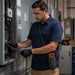 Electrician working at a panel, wearing the AgozTech Holster with Crossbody Sling for Klein Tools Multimeter 