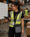 Person in a warehouse wearing a Panasonic tablet case and holding a tablet.