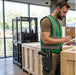 Warehouse worker wearing an AgozTech waist belt holster with a Keyence scan gun while inspecting shipping crates.