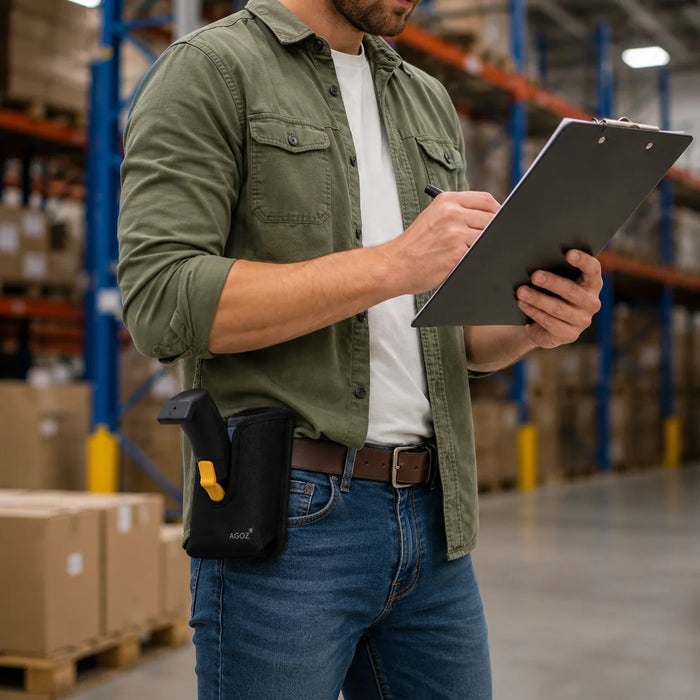 Warehouse employee carrying a Janam scanner grip while checking inventory