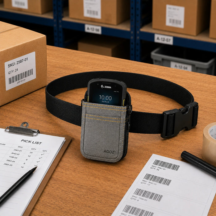 AGOZ gray waist case holding a Zebra rugged scanner on a warehouse packing table with a pick list, barcode labels, and shipping supplies.