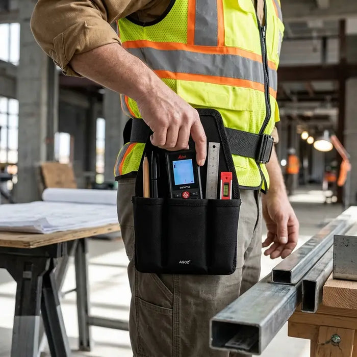 Close-up of construction worker accessing a Leica DISTO laser distance meter from an Agoz utility tool pouch attached to his waist belt.