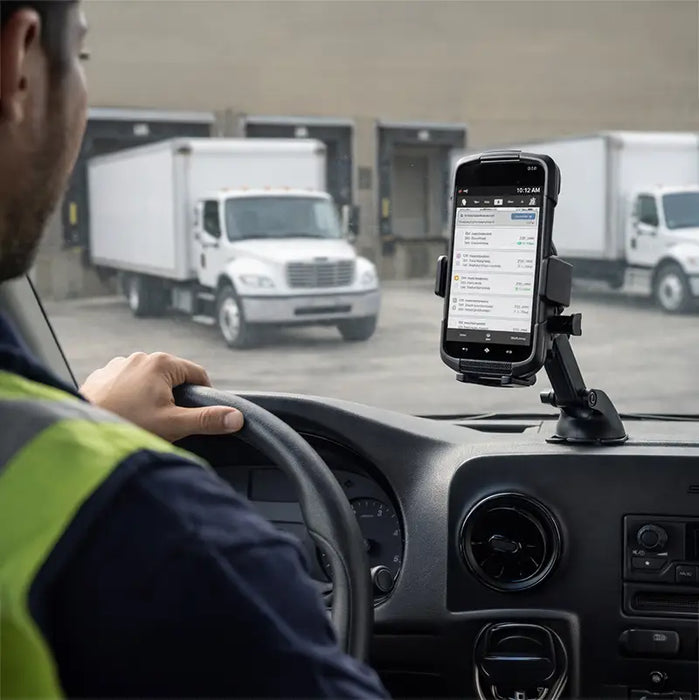 Driver using Zebra TC78 mobile computer in dashboard mount inside delivery vehicle