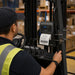 Warehouse forklift operator using an Agoz metal holder with Citizen mobile printer mounted near the forklift controls