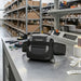 Honeywell RP4f mobile printer in waist belt carrying case on workbench in warehouse packing and labeling station.