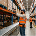 Warehouse worker wearing an Agoz WASP trigger scanner holster while scanning pallet labels during warehouse barcode workflows.