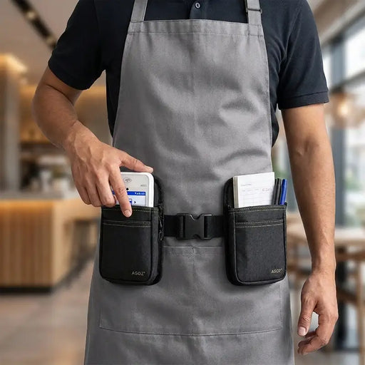 Close-up of restaurant employee retrieving a white PAX POS terminal from an Agoz double pouch waist belt holster, with guest checks and pens stored in the second pouch.
