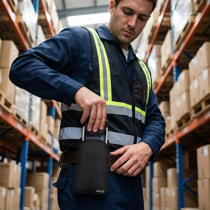 Warehouse worker inserting Zebra TC77 into AgozTech holster case on waist belt